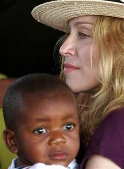 Madonna holds David as they leave Malawi