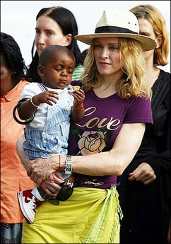 Madonna holds David as they leave Malawi