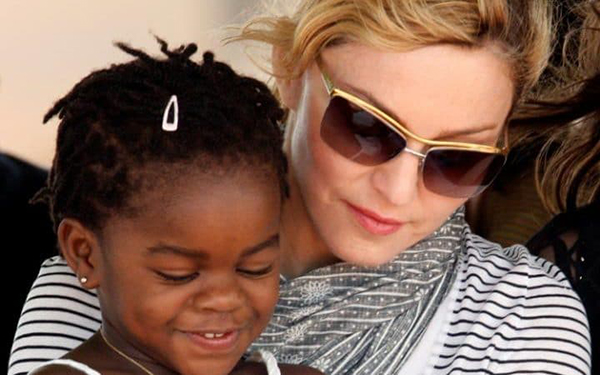 Pop star Madonna sits with her adopted Malawian child Mercy James during a bricklaying ceremony at the site of her Raising Malawi Girls Academy, near the capital Lilongwe, Malawi in 2010