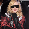 New York gal: Madonna, 58, rocked fishnets and chunky black ankle boots paired with a red and black coat that had a black fluffy trimmed hood