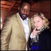 Madonna posed for a photograph with Malawian hip hop star Tay Grin at a party yesterday to celebrate the singer's first visit to the African country for 18 months